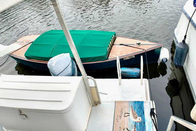 Amore Yacht Photos Pics 1996 Catamaran Cruisers Aqua Cruiser 44 docked with green-covered boat nearby.