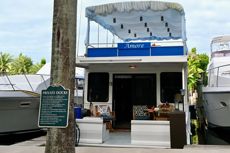 Amore Yacht Photos Pics 1996 Catamaran Cruisers Aqua Cruiser 44 docked, featuring outdoor seating and canopy.