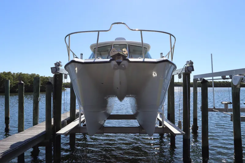  Yacht Photos Pics 2008 Glacier Bay 3080 Coastal Runner boat on lift at marina dock.