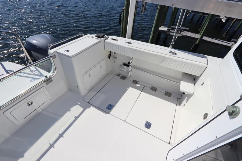  Yacht Photos Pics 2008 Glacier Bay 3080 Coastal Runner boat interior with seating and storage, docked by water.