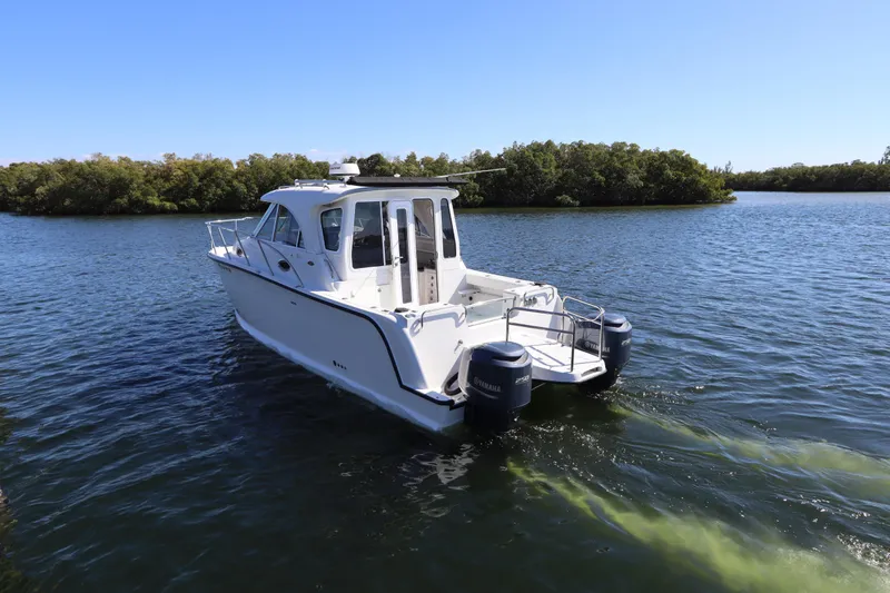  Yacht Photos Pics 2008 Glacier Bay 3080 Coastal Runner boat cruising on a serene lake.