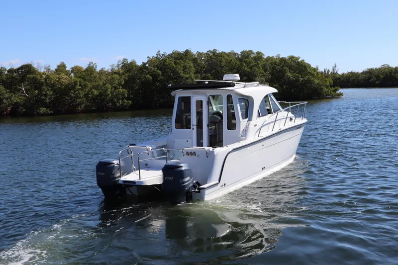  Yacht Photos Pics 2008 Glacier Bay 3080 Coastal Runner boat cruising on a serene waterway.