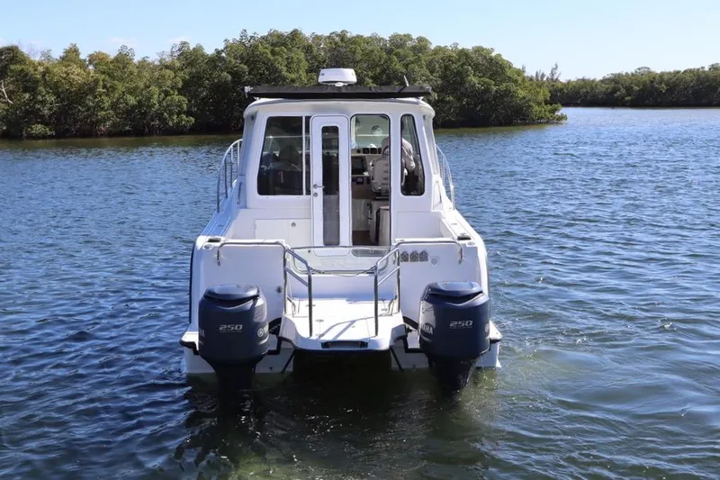  Yacht Photos Pics 2008 Glacier Bay 3080 Coastal Runner boat on water, rear view with twin engines.