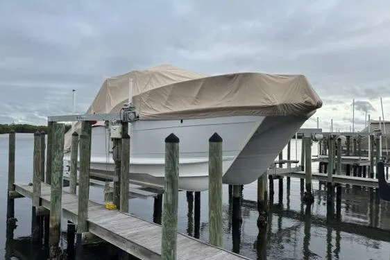  Yacht Photos Pics 2008 Glacier Bay 3080 Coastal Runner boat covered at dockside, overcast sky.