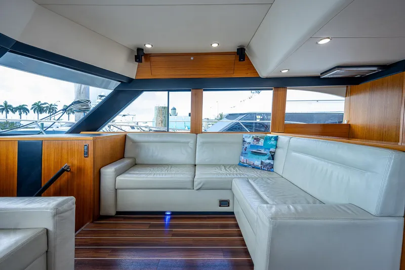 Three Wishes Yacht Photos Pics 2015 Maritimo M50 Motoryacht interior with white leather seating and wooden accents.