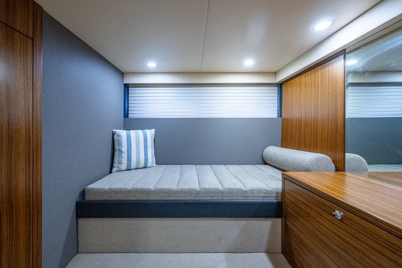 Three Wishes Yacht Photos Pics 2015 Maritimo M50 Motoryacht interior cabin with bed, wooden cabinetry, and modern lighting.