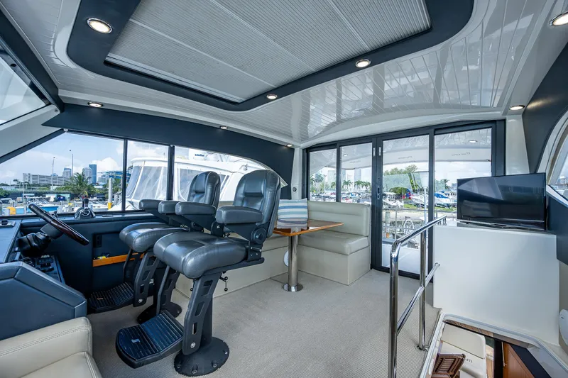 Three Wishes Yacht Photos Pics Luxurious interior of 2015 Maritimo M50 Motoryacht with helm seats and dining area.