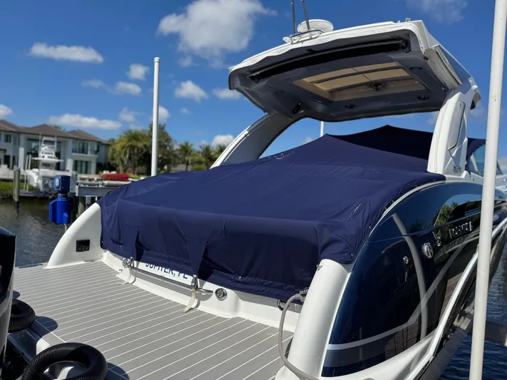 Uncorked Yacht Photos Pics 2023 Formula 350 Crossover Bowrider docked, covered, with blue sky background.