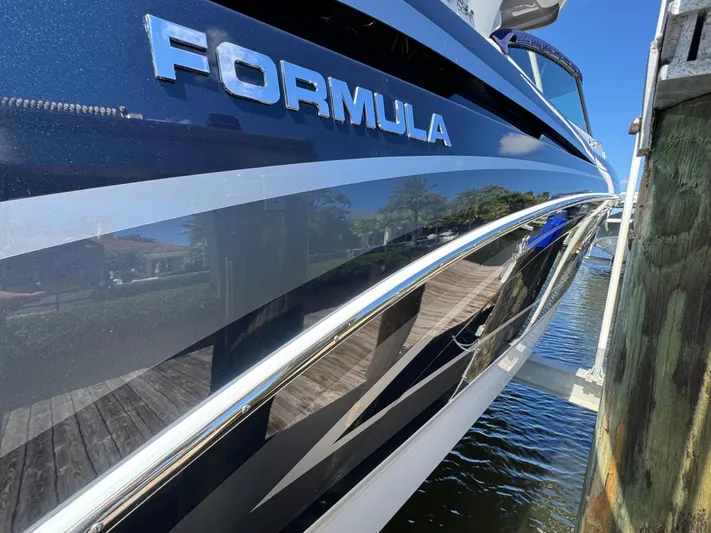 Uncorked Yacht Photos Pics 2023 Formula 350 Crossover Bowrider docked, showcasing sleek design and branding.