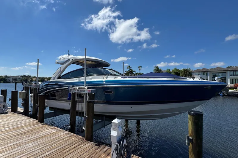Uncorked Yacht Photos Pics 2023 Formula 350 Crossover Bowrider docked, showcasing sleek design under a clear blue sky.