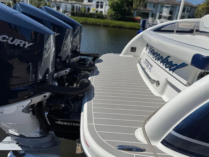 Uncorked Yacht Photos Pics 2023 Formula 350 Crossover Bowrider with Mercury engines docked by waterfront homes.