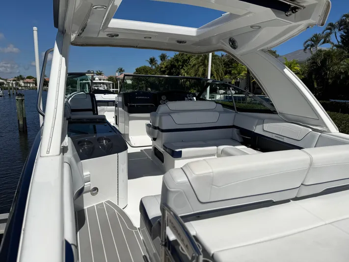 Uncorked Yacht Photos Pics 2023 Formula 350 Crossover Bowrider with spacious seating and sleek design on a sunny day.