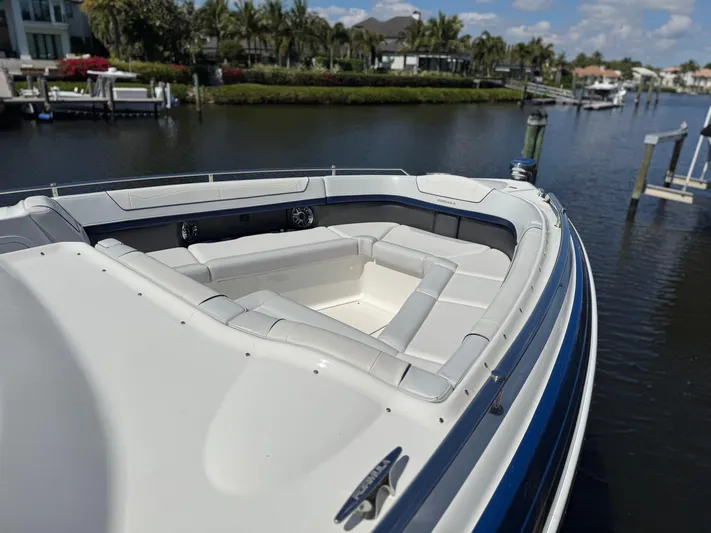 Uncorked Yacht Photos Pics 2023 Formula 350 Crossover Bowrider on a scenic waterfront, showcasing luxurious seating.