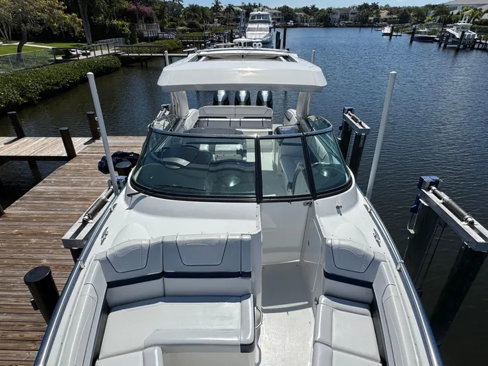 Uncorked Yacht Photos Pics 2023 Formula 350 Crossover Bowrider docked in a scenic marina setting.