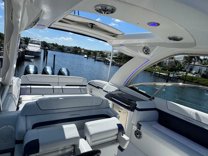 Uncorked Yacht Photos Pics 2023 Formula 350 Crossover Bowrider interior with luxurious seating and scenic waterfront view.