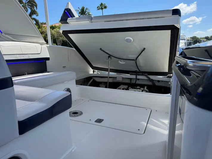 Uncorked Yacht Photos Pics 2023 Formula 350 Crossover Bowrider with open storage compartment, showcasing sleek interior design.