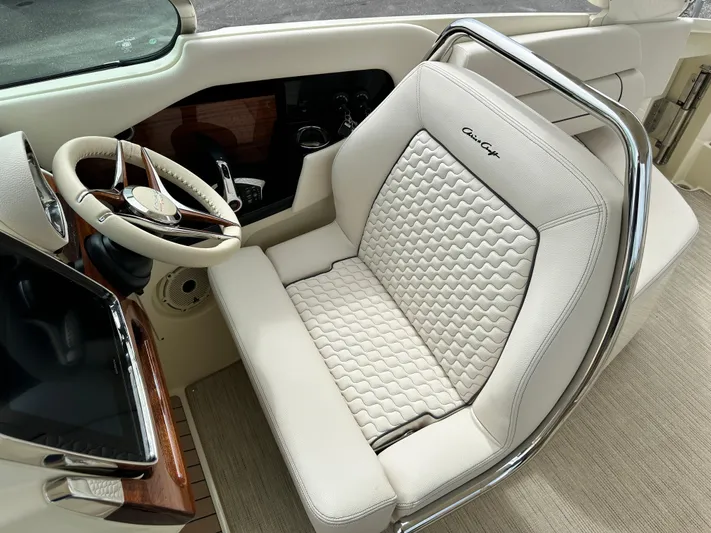  Yacht Photos Pics 2025 Chris-Craft Launch 31 GT helm seat with luxurious white upholstery and elegant design.