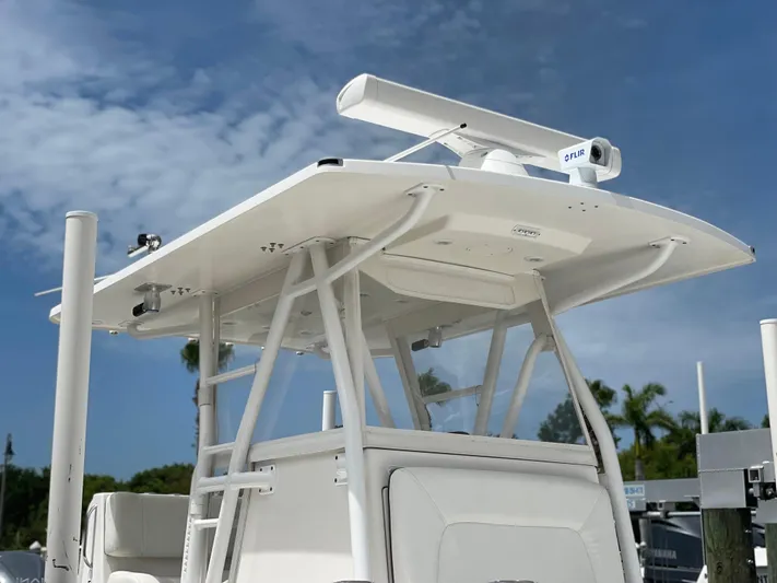  Yacht Photos Pics Invincible 36 CC 2011 boat with radar and T-top under clear sky.