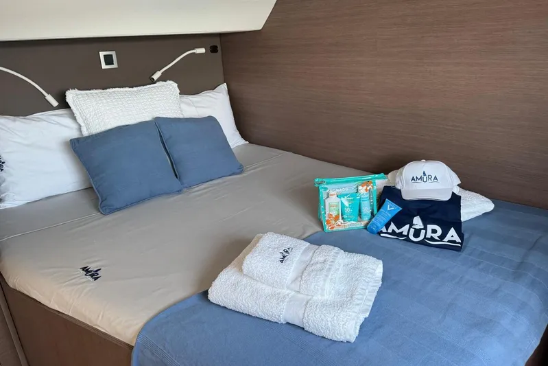 Amura Yacht Photos Pics Cozy cabin interior of 2021 Bali 5.4 Open Space with bedding and branded amenities.