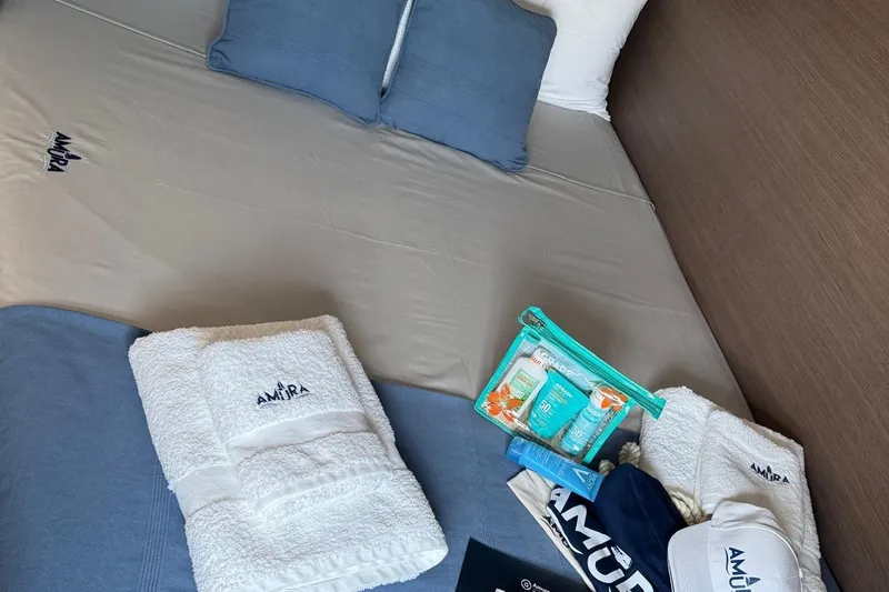 Amura Yacht Photos Pics Luxurious Bali 5.4 Open Space 2021 cabin with branded towels and toiletries.