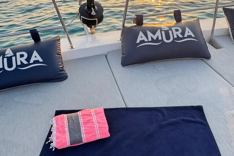 Amura Yacht Photos Pics Sunset view on Bali 5.4 Open Space yacht with cushions and towels, 2021 model.