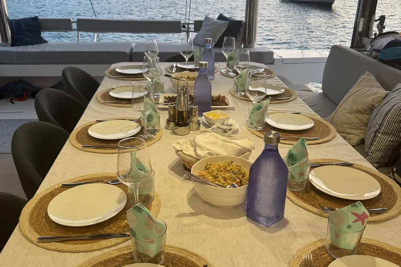 Amura Yacht Photos Pics Elegant dining setup on Bali 5.4 Open Space yacht, 2021, with ocean view.