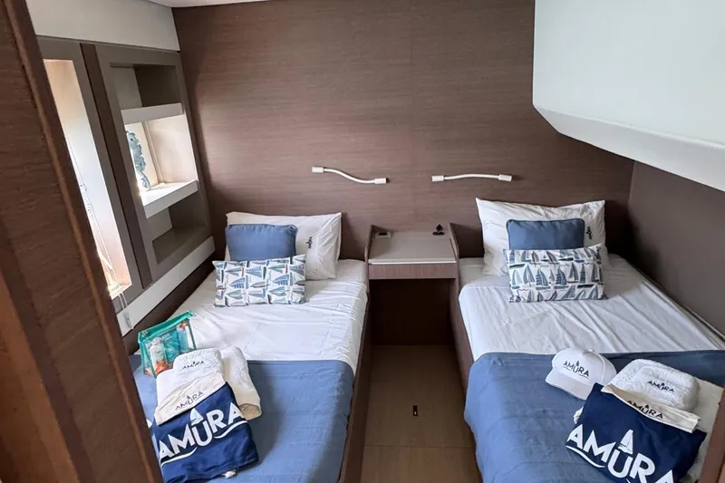 Amura Yacht Photos Pics Cabin interior of 2021 Bali 5.4 Open Space yacht with twin beds and nautical decor.