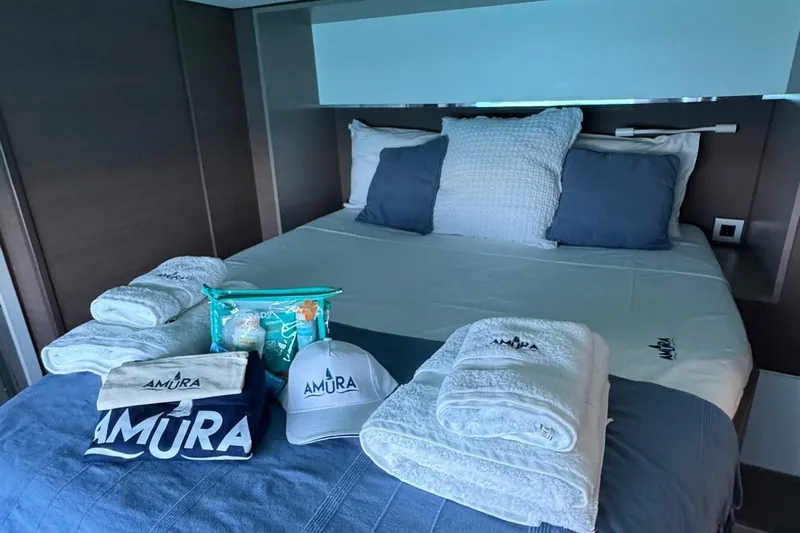 Amura Yacht Photos Pics Luxurious bedroom in 2021 Bali 5.4 Open Space yacht with branded towels and accessories.