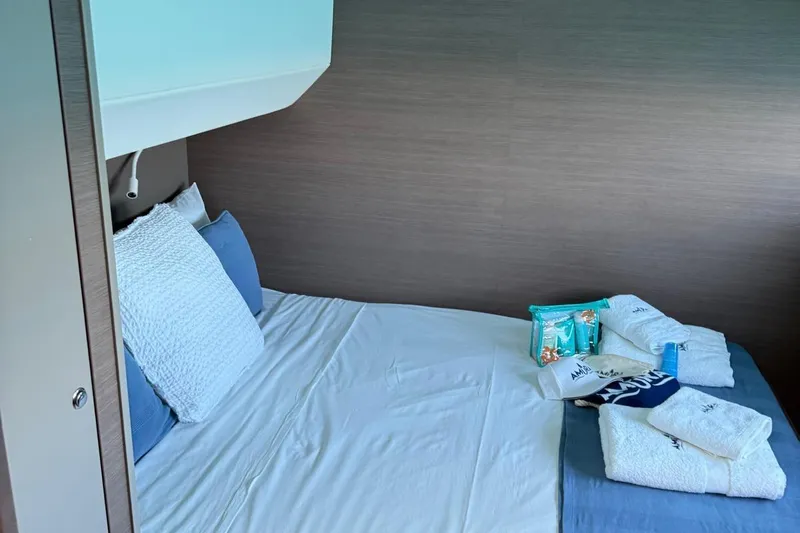 Amura Yacht Photos Pics Cozy cabin bed in 2021 Bali 5.4 Open Space yacht with towels and toiletries.