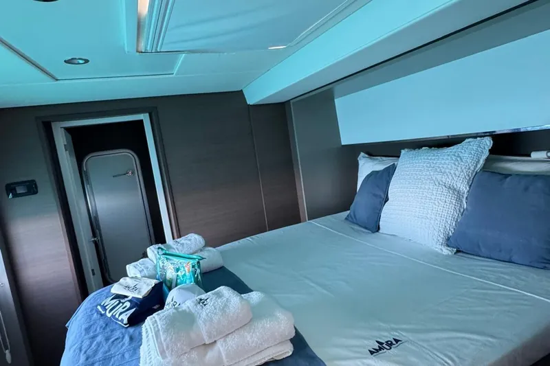 Amura Yacht Photos Pics Luxurious cabin interior of 2021 Bali 5.4 Open Space yacht with neatly arranged bedding.