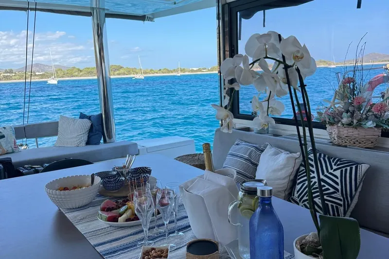 Amura Yacht Photos Pics Luxurious Bali 5.4 Open Space yacht interior with elegant dining setup and ocean view, 2021 model.