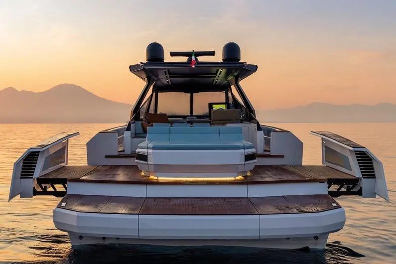  Yacht Photos Pics 2026 Evo Yachts R6 at sunset, showcasing sleek design and luxurious features on calm waters.