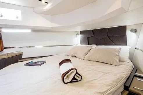  Yacht Photos Pics Luxurious cabin interior of 2026 Evo Yachts R6, featuring a cozy bed and modern design.