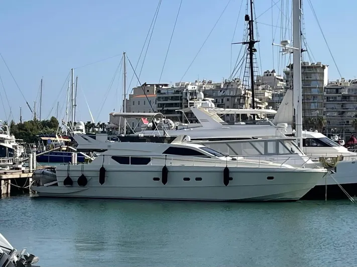 Ferretti 55 Yacht Photos Pics 1998 Ferretti Yachts FERRETTI 55 docked in a marina, surrounded by other boats.