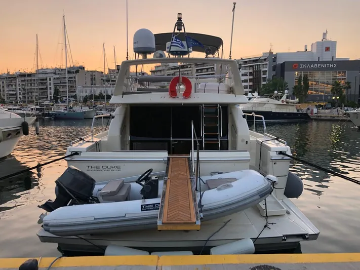 Ferretti 55 Yacht Photos Pics 1998 Ferretti Yachts FERRETTI 55 docked at sunset with inflatable boat.