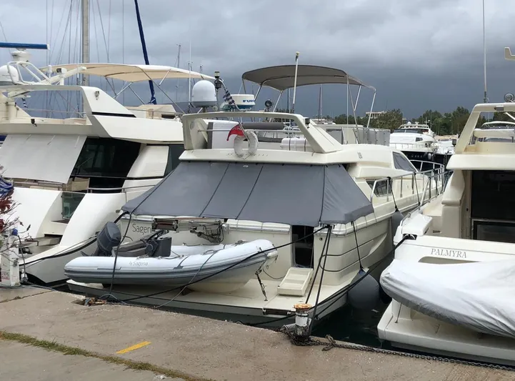 Ferretti 55 Yacht Photos Pics Ferretti Yachts FERRETTI 55, 1998 model, docked at marina with inflatable boat.