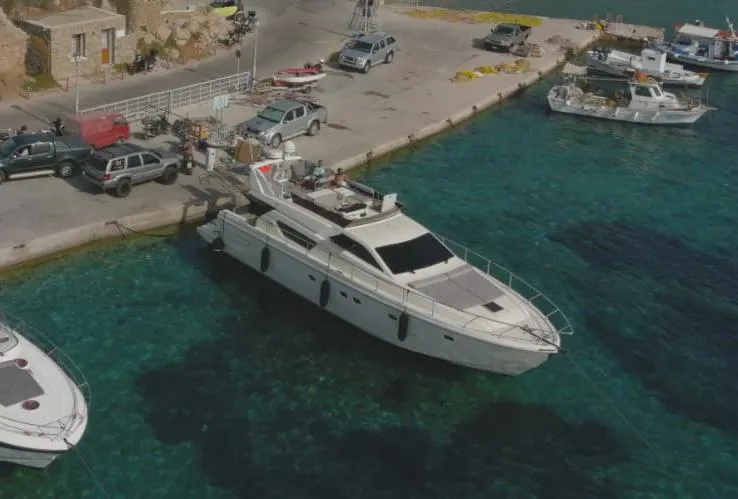 Ferretti 55 Yacht Photos Pics 1998 Ferretti Yachts FERRETTI 55 docked at a scenic marina with clear blue water.