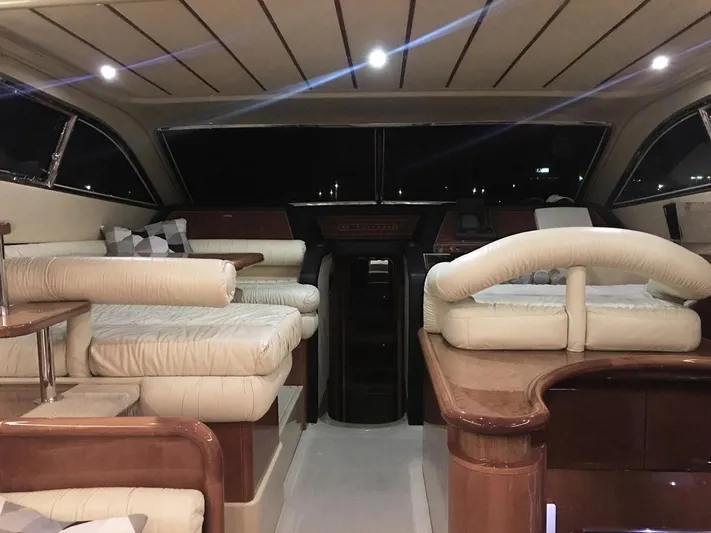 Ferretti 55 Yacht Photos Pics Luxurious interior of a 1998 Ferretti Yachts FERRETTI 55 with elegant seating and wood finishes.