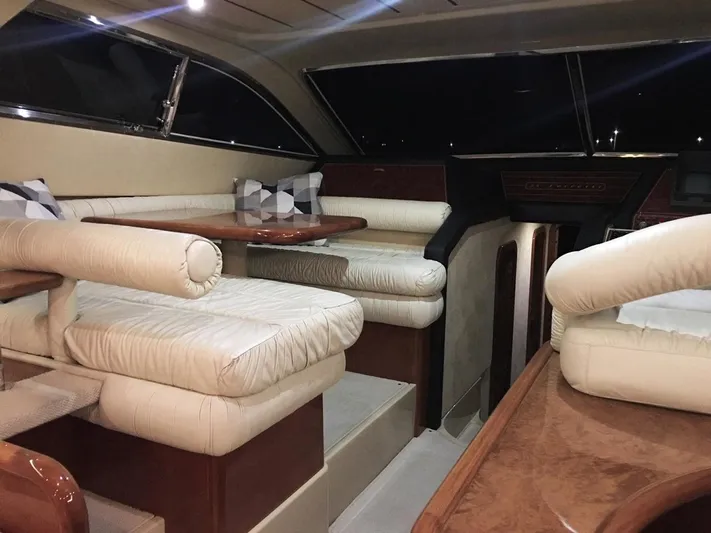 Ferretti 55 Yacht Photos Pics Luxurious interior of 1998 Ferretti Yachts FERRETTI 55 with plush seating and elegant wood finishes.