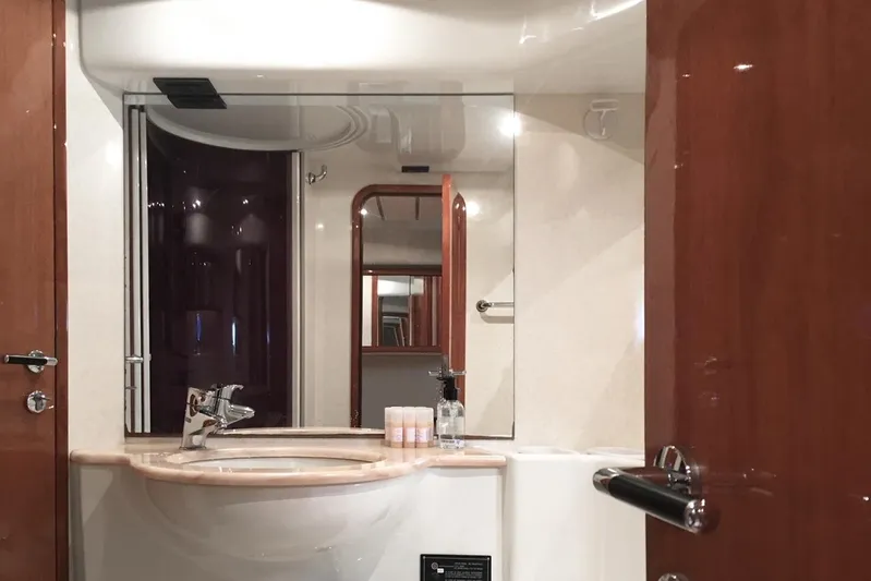 Ferretti 55 Yacht Photos Pics Luxurious bathroom interior of 1998 Ferretti Yachts FERRETTI 55, featuring elegant fixtures and mirror.