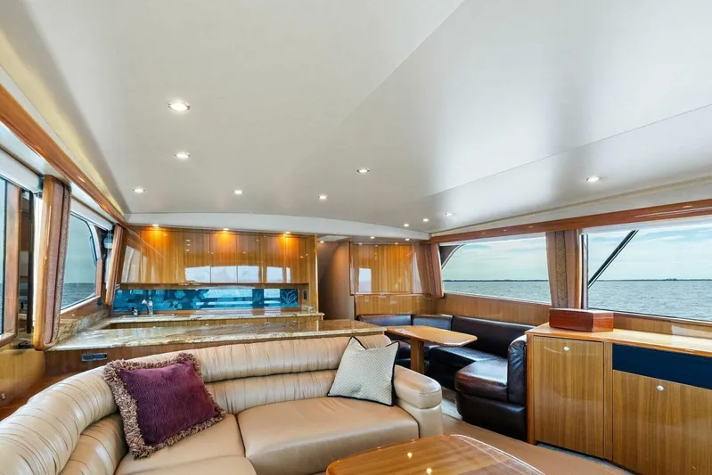 Knot On Call Yacht Photos Pics Luxurious interior of 2006 Viking 61 Convertible yacht with elegant wood finishes and ocean view.