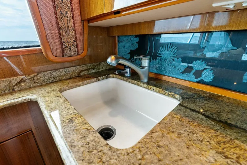 Knot On Call Yacht Photos Pics Luxurious kitchen sink with granite countertop on 2006 Viking 61 Convertible yacht.