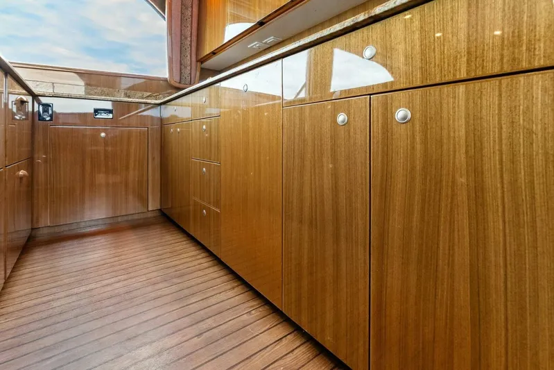 Knot On Call Yacht Photos Pics Luxurious wooden cabinetry inside a 2006 Viking 61 Convertible yacht, showcasing sleek design.