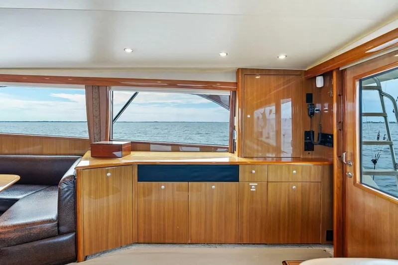 Knot On Call Yacht Photos Pics Interior of 2006 Viking 61 Convertible yacht with wooden cabinetry and ocean view.