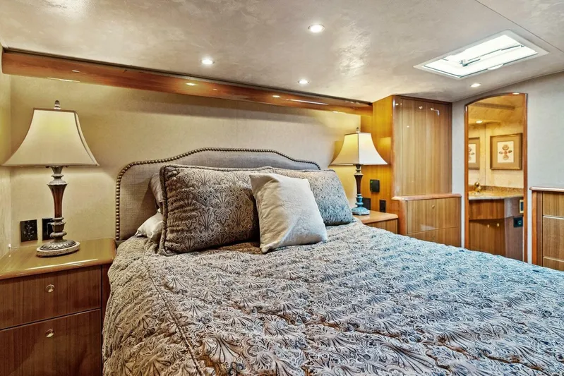 Knot On Call Yacht Photos Pics Luxurious bedroom interior of 2006 Viking 61 Convertible yacht with elegant bedding and lighting.