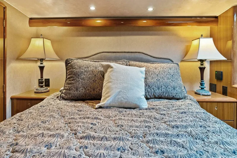 Knot On Call Yacht Photos Pics Luxurious bedroom interior of 2006 Viking 61 Convertible yacht with elegant bedding and lamps.