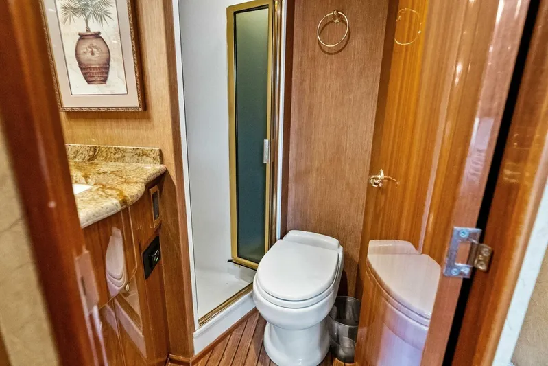 Knot On Call Yacht Photos Pics Luxurious bathroom in 2006 Viking 61 Convertible yacht with wood accents and modern fixtures.