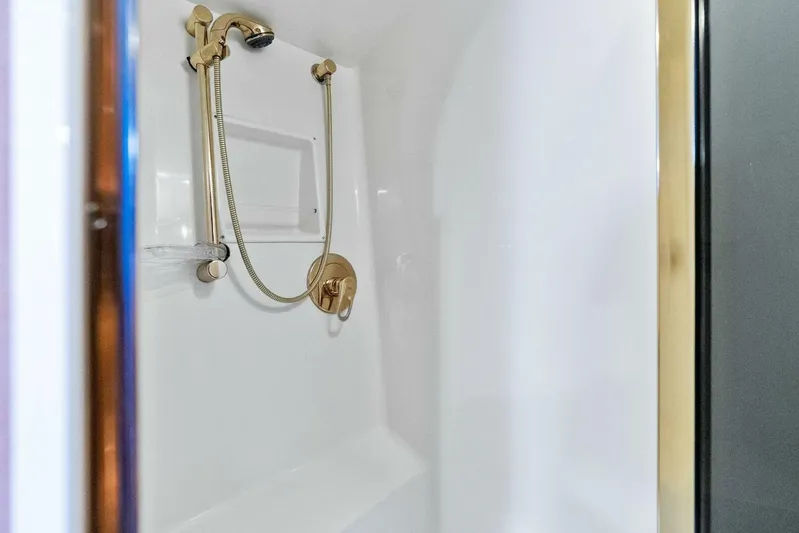 Knot On Call Yacht Photos Pics Luxurious shower in 2006 Viking 61 Convertible yacht with gold fixtures.