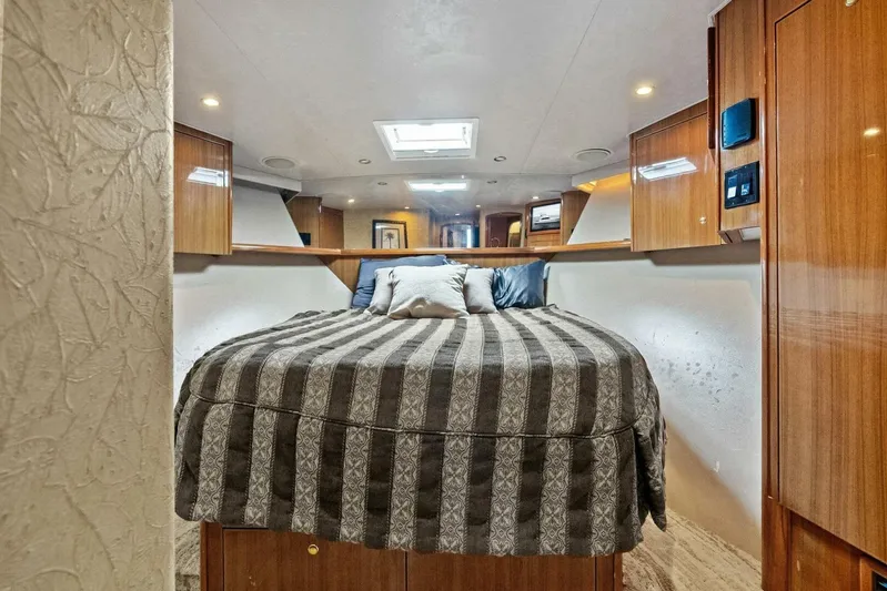 Knot On Call Yacht Photos Pics Luxurious bedroom interior of a 2006 Viking 61 Convertible yacht with elegant wood finishes.
