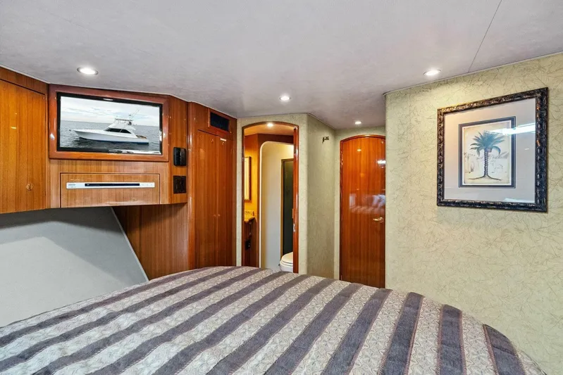 Knot On Call Yacht Photos Pics Luxurious interior of 2006 Viking 61 Convertible yacht with wood paneling and framed artwork.